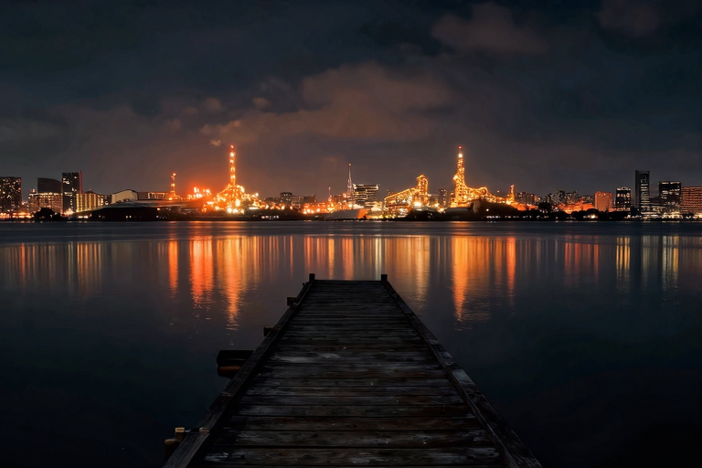 nighttime coastal scene, old wooden pier extending into tokyo bay, factory lights reflecting on calm water, dark sky with subtle stars, abandoned atmosphere, no people, moody cinematic, anime style, masterpiece, very aesthetic, score_9, score_8_up