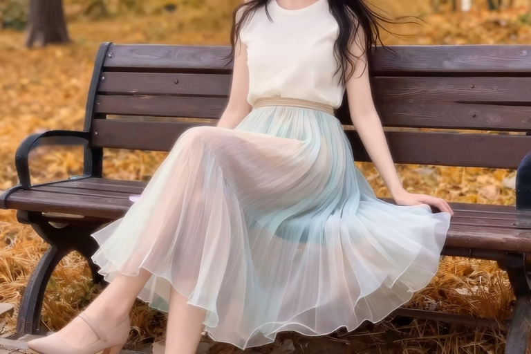 シフォンのフレアスカートを着た女性、公園のベンチに座っている